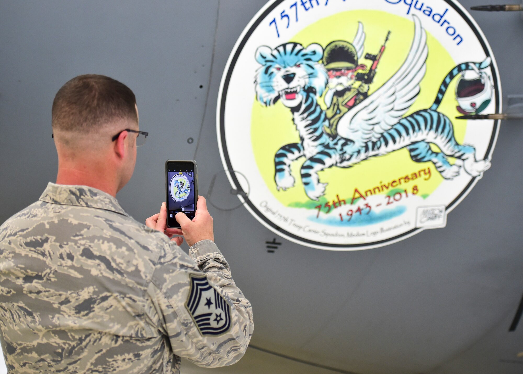 Youngstown State University President Jim Tressel gives remarks during a ceremony to unveil a new C-130H Hercules tail flash and nose art here, May 3, 2018.