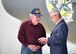 Lt. Col. (ret.) John Wingerter, a former pilot with the 757th Airlift Squadron here, talks with Youngstown State University President Jim Tressel, in front of C-130H Hercules nose art depicting the 757th AS Blue Tiger mascot in honor of the 75th anniversary of the 757th AS after an unveiling ceremony here, May 3, 2018.