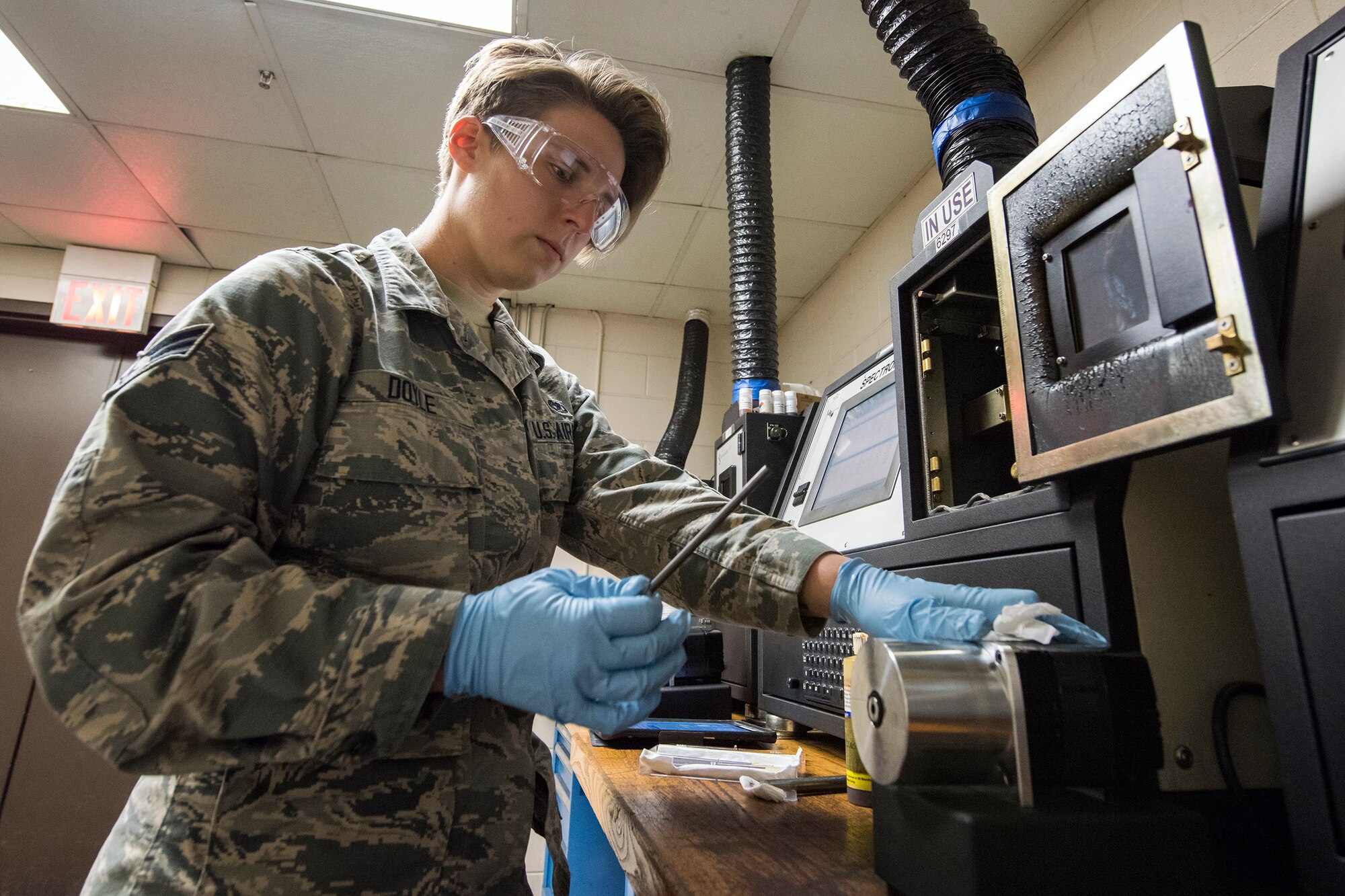 Senior Airman Louisa Doyle, 23d Maintenance Squadron non-destructive inspection (NDI) specialist, examines a steel rod, May 2, 2018, at Moody Air Force Base, Ga. NDI technicians use various methods to complete these inspections such as X-ray, florescent dye penetrant, oil analysis and ultrasonic scanning to examine and inspect numerous aircraft parts and components to ensure that they are in usable condition. (U.S. Air Force photo by Airman 1st Class Eugene Oliver)