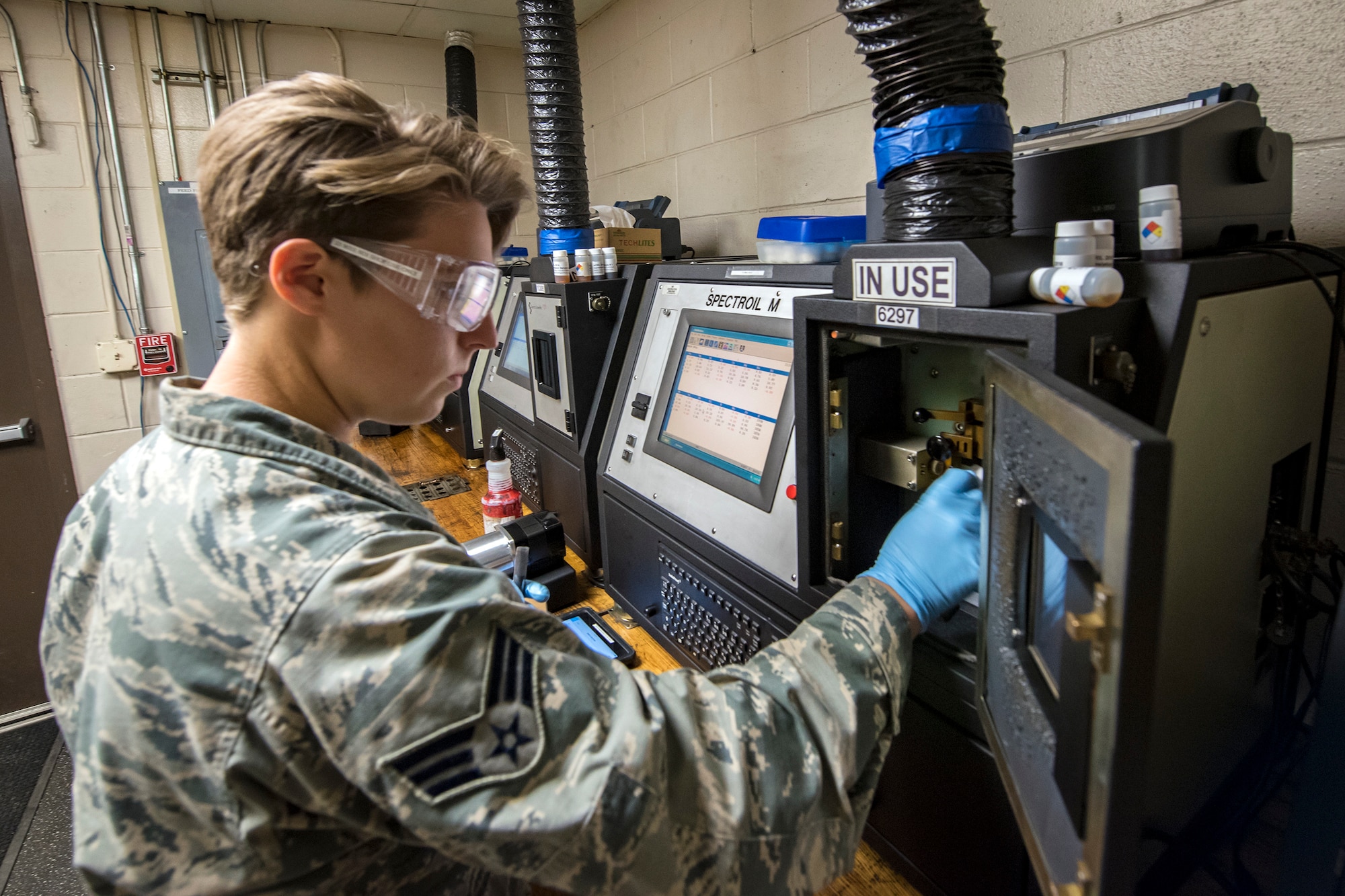Senior Airman Louisa Doyle, 23d Maintenance Squadron non-destructive inspection (NDI) specialist, places an oil sample inside of a joint oil analysis program machine, May 2, 2018, at Moody Air Force Base, Ga. NDI technicians use various methods to complete these inspections such as X-ray, florescent dye penetrant, oil analysis and ultrasonic scanning to examine and inspect numerous aircraft parts and components to ensure that they are in usable condition. (U.S. Air Force photo by Airman 1st Class Eugene Oliver)