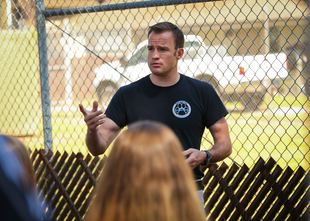 Officer Matthew Buckley teaches students about Military Working Dogs aboard Marine Corps Air Station Beaufort May 1. The demonstration was held for students from Beaufort Middle School to showcase one of the main assets of the air station. Buckle is a MWD handler with the Provost Marshals Office.