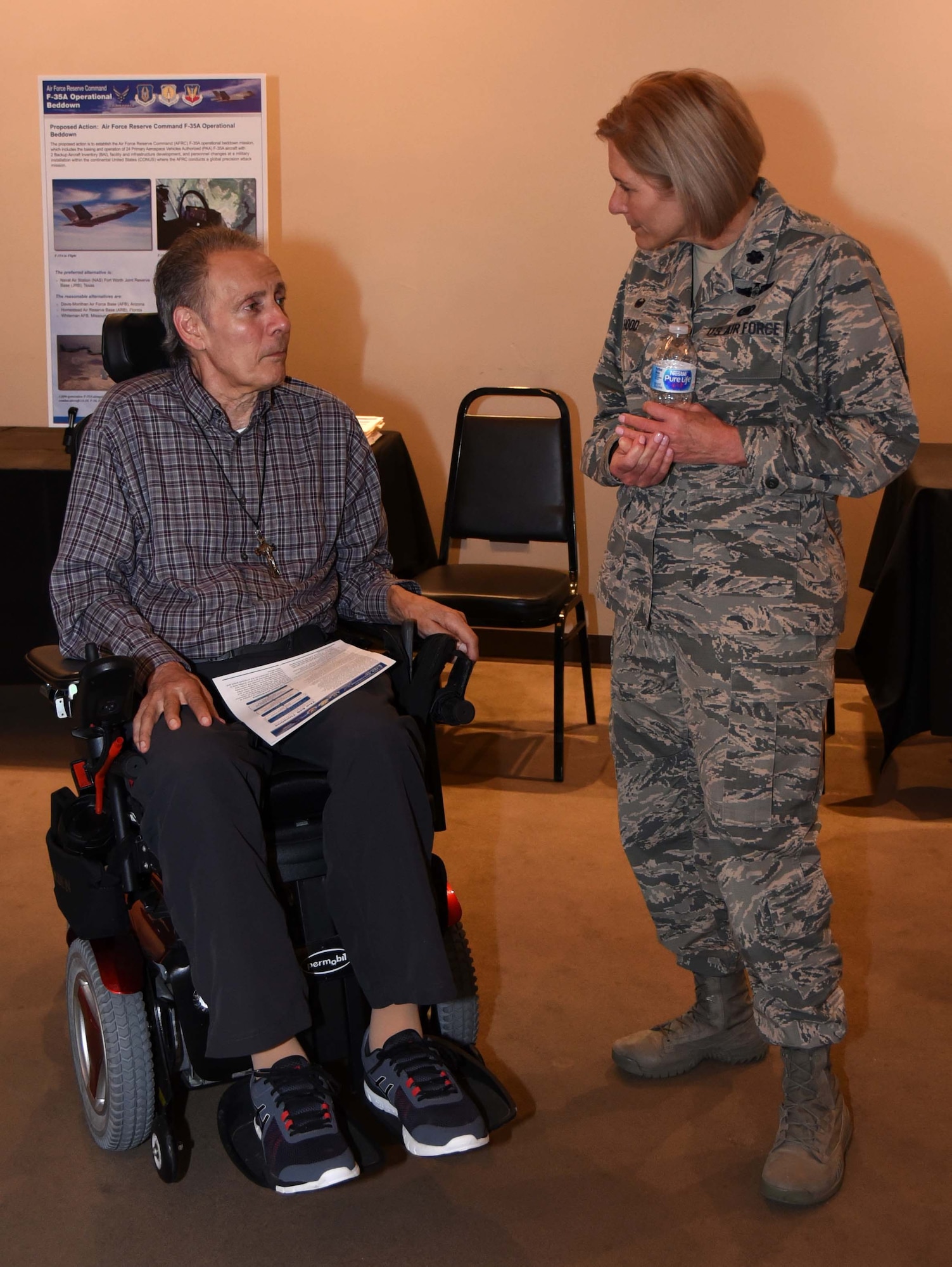 Lt. Col. Trina Hood, 301st Fighter Wing Mission Support Group Commander, at Naval Air Station Fort Worth Joint Reserve Base, Texas, meets with a local resident at the F-35A Environmental Impact Statement (EIS) Public Scoping Meeting April 19, 2018 in Fort Worth, Texas. The meeting solicited comments from the community about the F-35A aircraft bed down that would replace the current F-16 mission. The community can still give comments at http://www.afrc-f35a-beddown.com until May 11, 2018. (U.S. Air Force photo by Tech. Sgt. Charles Taylor)