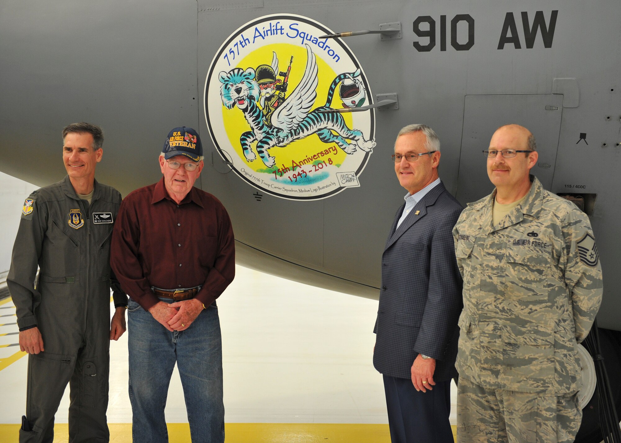 910th Airlift Wing Commander Col. Dan Sarachene, former 757th Airlift Squadron pilot Lt. Col. (Ret.) John Wingerter, Youngstown State University President and Honorary 910th Airlift Wing Commander Jim Tressel and aircraft 3022 crew chief Master Sgt. Brian McCumbers, with the 910th Aircraft Maintenance Squadron (left to right) pose for a photo in front of the new C-130H Hercules flagship nose art May 3, 2018, in hangar 305 here.