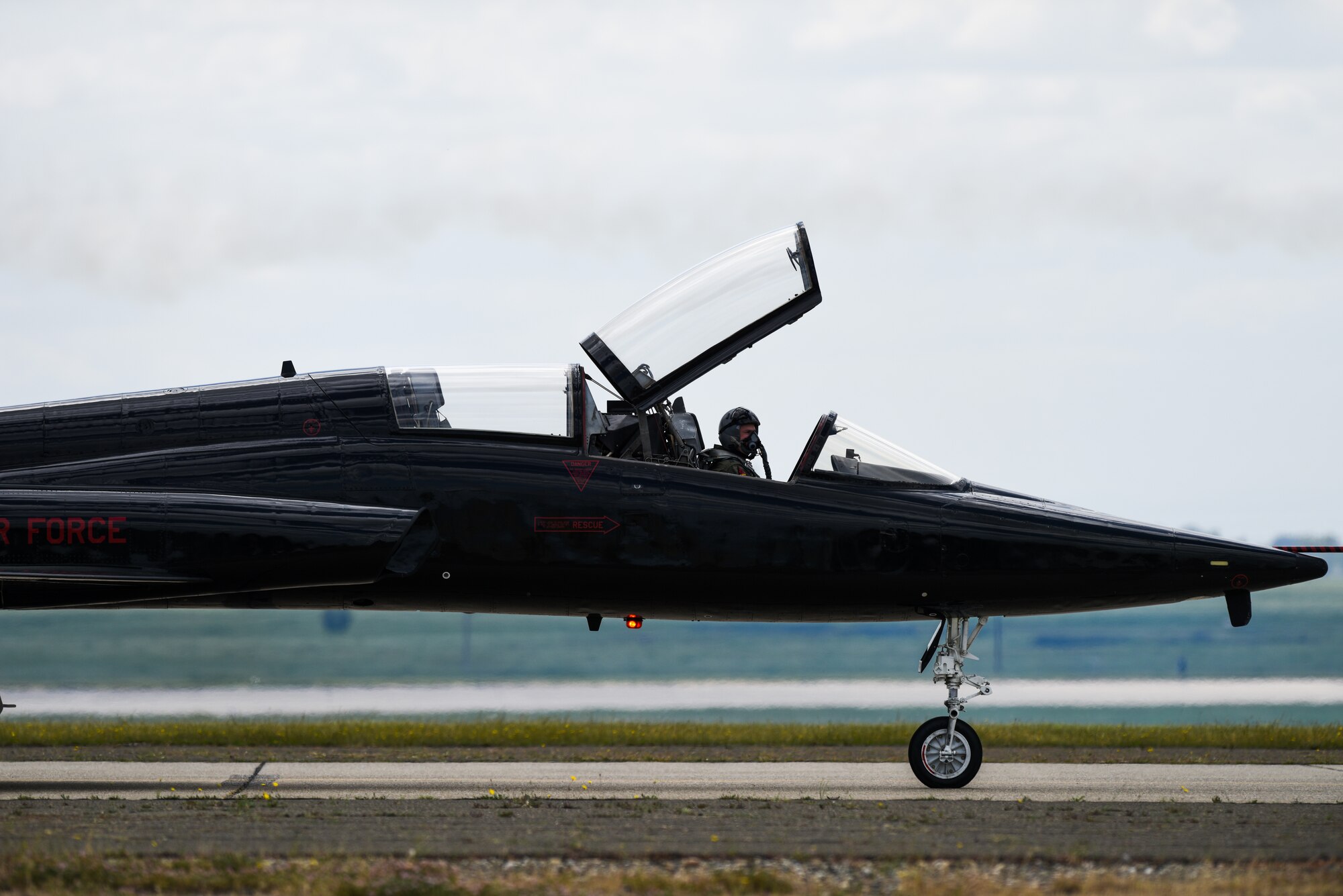 A T-38 Talon pilot looks out at the crowd during the Air and Space Expo at Beale Air Force Base, California, April 27, 2018. The T-38 is one of two air craft stationed here at Beale in support of the 9th Reconnaissance Wing mission. (U.S Air Force photo/Senior Airman Justin Parsons)