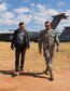 Simon Sinek, author and optimist, and U.S. Air Force Col. Scott Campbell, 355th Fighter Wing commander, walk through the 309th Aerospace Maintenance and Regeneration Group at Davis-Monthan Air Force Base, Ariz., May 2, 2018.