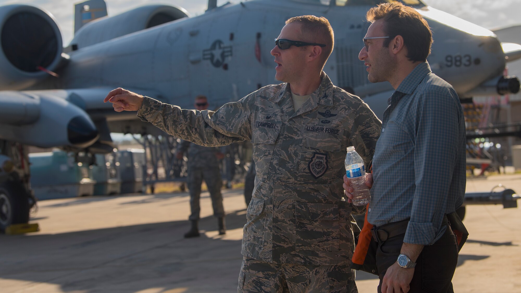 Simon Sinek, author and optimist, speaks with U.S. Air Force Col. Scott Campbell, 355th Fighter Wing commander at Davis-Monthan Air Force Base, Ariz., May 2, 2018.