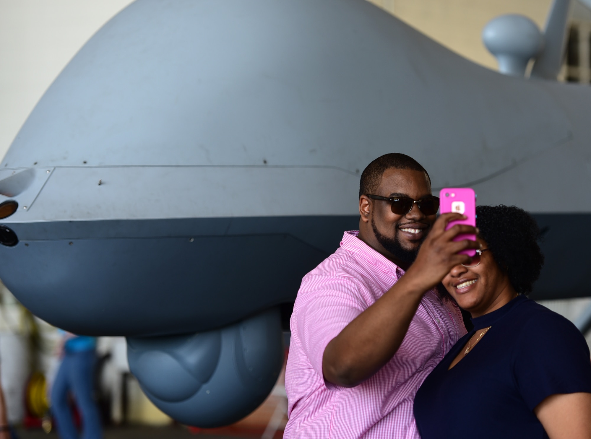 A couple takes a selfie in front of the MQ-9 Reaper April 28, 2018, at the Joint Base Charleston Air & Space Expo at JB Charleston, S.C. MQ-9 crews were able to answer questions and educate the public on their persistent attack and reconnaissance mission. (U.S. Air Force photo by Senior Airman Christian Clausen)