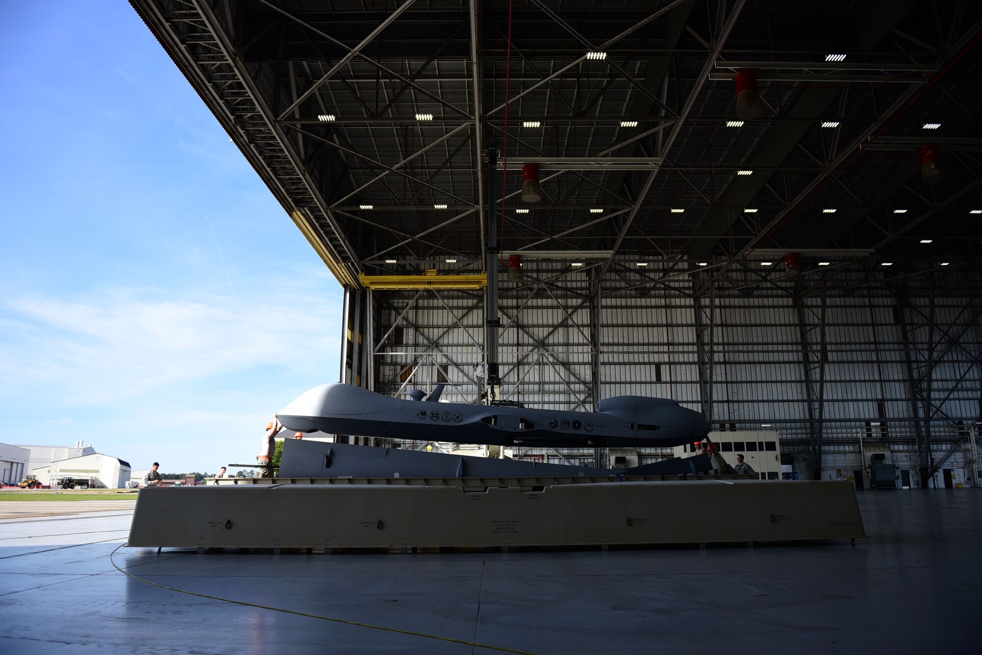 Airmen from the 432nd Wing/432nd Air Expeditionary Wing assemble an MQ-9 Reaper for display at the Joint Base Charleston Air & Space Expo April 26, 2018, at JB Charleston, S.C. The air show provided the opportunity to educate the public on combat Remotely Piloted Aircraft capabilities and operations. (U.S. Air Force photo by Senior Airman Christian Clausen)