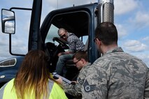 Senior Airman Devin Needs, 100th Logistics Readiness Squadron vehicle operator, center, receives feedback on his driving performance during a course inspection at Royal Air Force Mildenhall, England, April 26, 2018. The inspection verified procedures and the course layout to be used for a commercial driver’s licensure program. (U.S. Air Force photo/Senior Airman Abby L. Finkel)