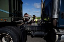 Staff Sgt. Alexander Lawrence, 100th Logistics Readiness Squadron training and validation office examiner, center, performs a vehicle check during a course inspection at Royal Air Force Mildenhall, England, April 26, 2018. The CDL course is part of an Air Force-wide initiative, with RAF Lakenheath and RAF Mildenhall set to be the first bases to implement the program in the U.S. Air Forces in Europe. (U.S. Air Force photo/Senior Airman Abby L. Finkel)