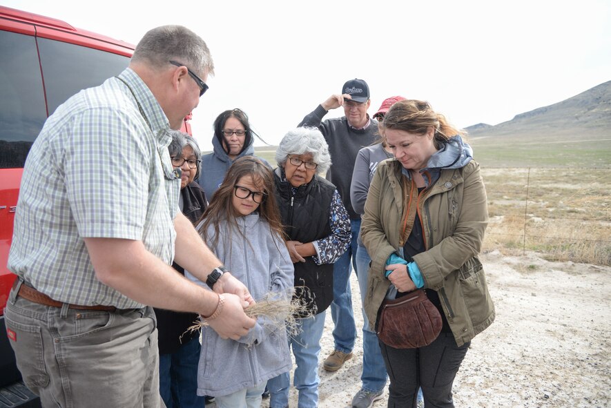 Russ Lawrence, Natural Resources Manager at the Utah Test and Training Range, talks about how the UTTR is gradually working on getting rid of cheat grass and cultivating more natural growth of better and nutritious vegetation for the land and wildlife. The exchange occurred on a tour of the range April 20, 2018, during Annual American Indian Meeting, in which Hill Air Force Base was a co-host. The meeting was held for government-to-government conversations, tours of UTTR, and official tribal co-host presentations. (U.S. Air Force photo by Cynthia Griggs)