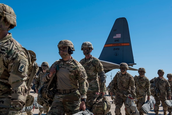 Paratroopers with 1st Battalion (Airborne), 143rd Infantry Regiment, Texas Army National Guard, prepare to initiate an airborne assault by jumping from a C-130H Hercules over Denison, Texas, April 20, 2018.