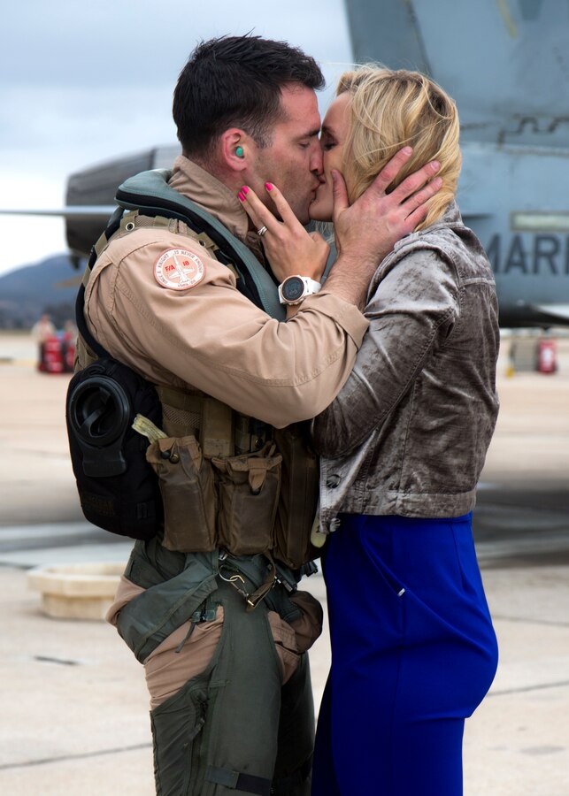 Capt. Robert Ahern, an F/A-18C Hornet pilot with Marine Fighter Attack Squadron (VMFA) 314, Marine Aircraft Group 11, 3rd Marine Aircraft Wing, kisses his wife at Marine Corps Air Station Miramar, Calif., after coming home from a six-month deployment May 2. Marines with VMFA-314 returned home following their deployment with Special Purpose Marine Air-Ground Task Force - Crisis Response - Central Command. (U.S. Marine Corps photo by Cpl. Joshua S. McAlpine/ Released)