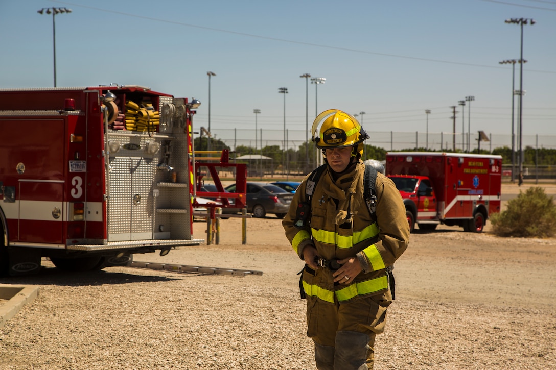 Two newly hired firefighters with Marine Corps Air Station (MCAS) Yuma’s fire department conduct “New Hire Training” at the stations fire department training building aboard MCAS Yuma, Ariz., Tuesday, April 17, 2018. The training teaches new firefighters all the basic skills they need to be successful at their job. This includes: how to climb the ladder, basic EMS training, how to employ and use the fire hose, and rescue drags used for removing civilians from dangerous environments. (U.S. Marine Corps photo by Cpl. Isaac D. Martinez)