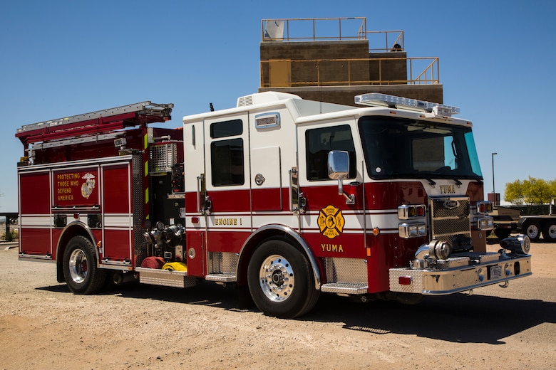 Two newly hired firefighters with Marine Corps Air Station (MCAS) Yuma’s fire department conduct “New Hire Training” at the stations fire department training building aboard MCAS Yuma, Ariz., Tuesday, April 17, 2018. The training teaches new firefighters all the basic skills they need to be successful at their job. This includes: how to climb the ladder, basic EMS training, how to employ and use the fire hose, and rescue drags used for removing civilians from dangerous environments. (U.S. Marine Corps photo by Cpl. Isaac D. Martinez)