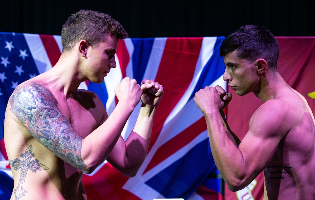 U.S. Marine Corps Cpl. Christian Valdes, right, an aviation logistics information management and support specialist with Marine Aviation Logistics Squadron 39 and boxer with the 1st Marine Division boxing team, faces his opponent British Royal Marine 1st Class Danny Smith, during the official weigh-in at the Commando Training Centre for the Royal Marines Lympstone, England, May 3, 2018. The 1st MARDIV boxing team and RMs were scheduled to compete in a friendly boxing exposition to strengthen the bond of both counterparts.