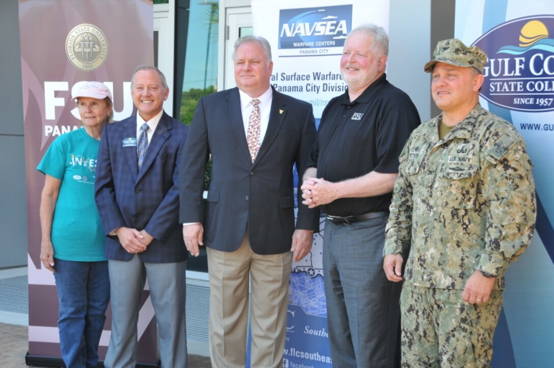 The 2018 Invention Convention, hosted April 28, 2018, was the product of an education partnership agreement signed by Naval Surface Warfare Center Panama City Division, Bay District Schools, Florida State University and Gulf Coast State College. Pictured here, from left to right, is BDS Board Member Ginger Littleton, GCSC Vice President for Strategic Initiatives Glen McDonald, NSWC PCD Technical Director Ed Stewart (SES), FSU PC Dean Randy Hanna, and NSWC PCD Commanding Officer Capt. Aaron Peters, USN. The 2018 Invention Convention featured a science fair for middle school to college students and technical capabilities, such as SEAL Delivery Vehicles, underwater unmanned vehicles, unmanned aviation systems and Navy diving technologies, presently being fielded at NSWC PCD. The goal of the event was to make science accessible to everyone, regardless of cost. (Released) U.S. Navy photo by Jacqui Barker, NSWC PCD.