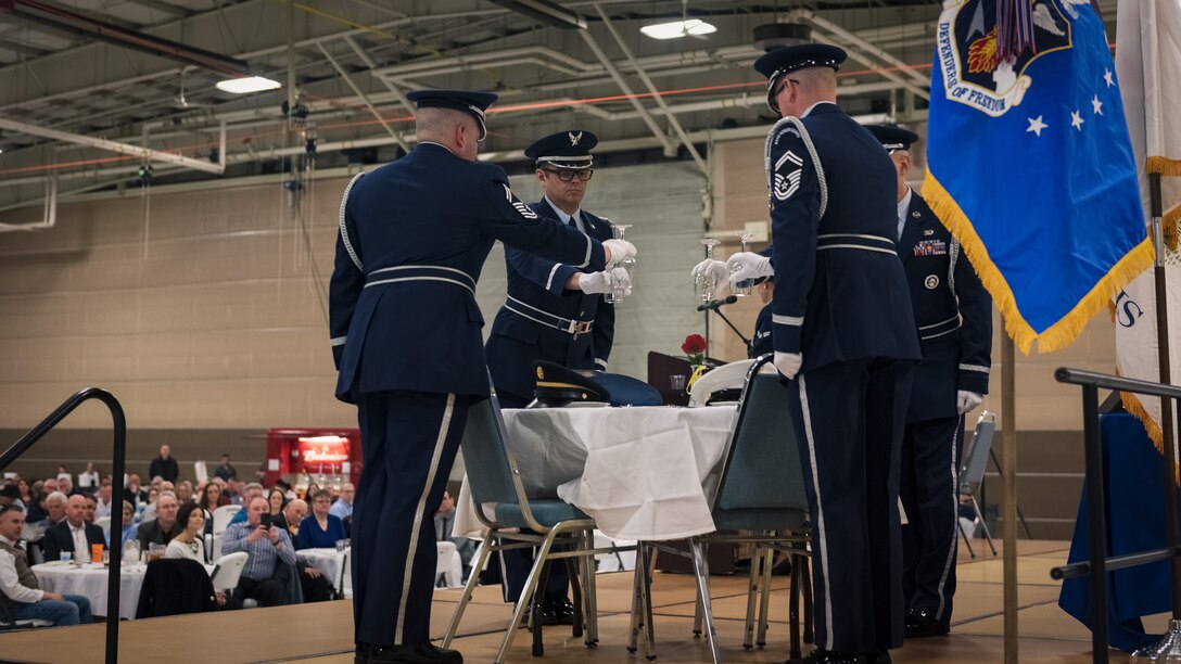 The 182nd Color Guard team inverts glasses while performing the Prisoner of War and Missing in Action ceremony during the 182nd Airlift Wing’s annual retirement dinner in Peoria, Ill., April 7, 2018.