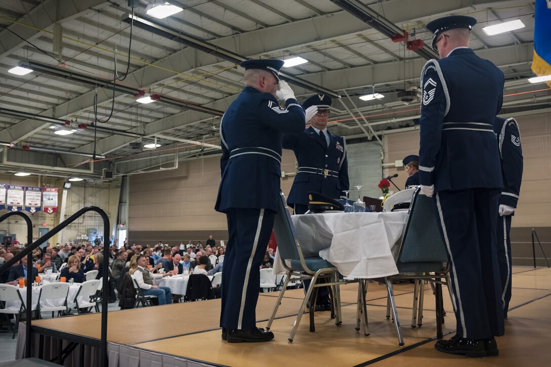 The 182nd Color Guard team salutes while performing the Prisoner of War and Missing in Action ceremony during the 182nd Airlift Wing’s annual retirement dinner in Peoria, Ill., April 7, 2018.