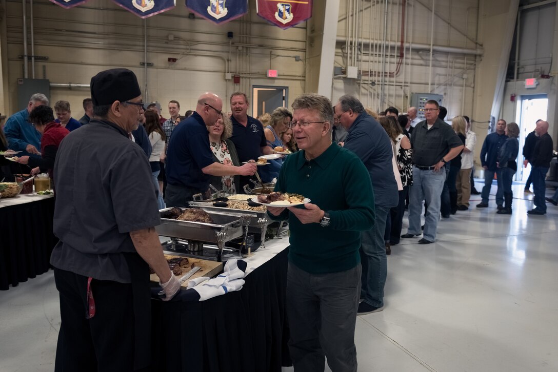 Current and former Airmen and their families enjoy a catered dinner during the 182nd Airlift Wing’s annual retirement dinner in Peoria, Ill., April 7, 2018.