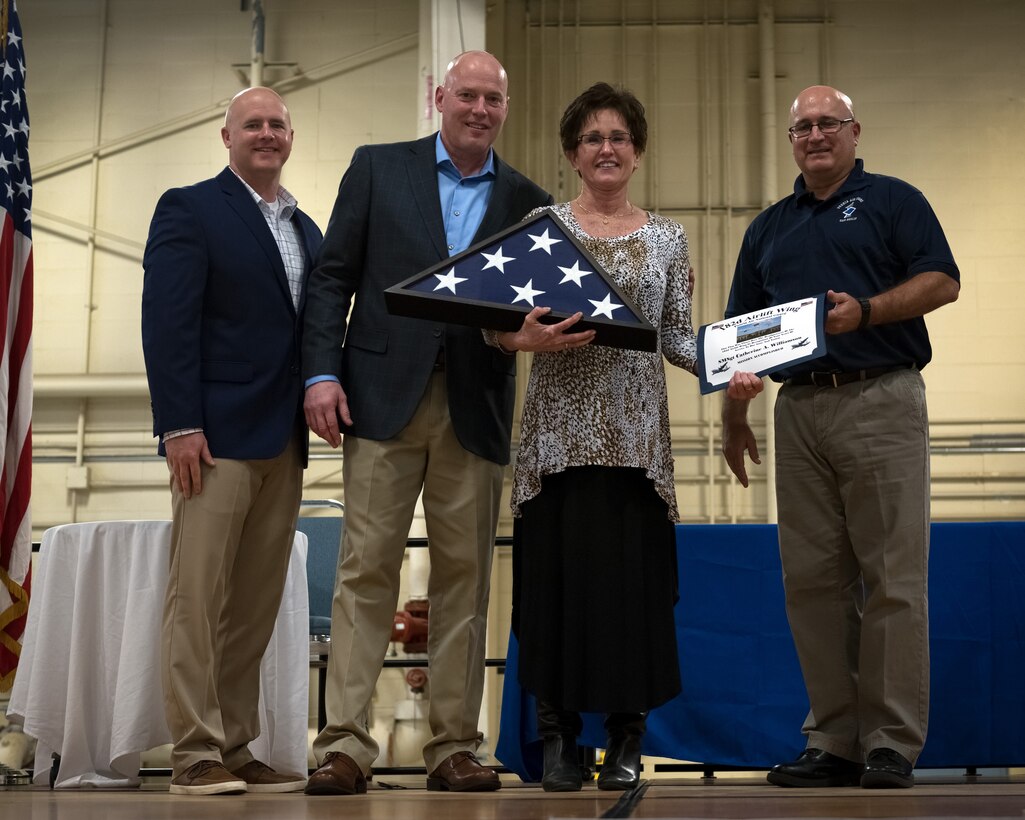 U.S. Air Force retired Senior Master Sgt. Catherine “Annie” Williamson, formerly of the 182nd Operations Support Squadron, Illinois Air National Guard, receives a unit-flown flag and certificate honoring her military service during the 182nd Airlift Wing’s annual retirement dinner in Peoria, Ill., April 7, 2018.