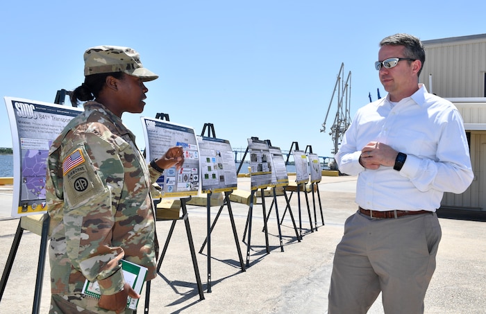 U.S. Army Maj. Tauara Hodo, left, 841st Transportation Battalion executive officer, briefs Rick Trimble, right, military legislative assistant to Senator Tim Scott, on the role of the 841st Trans Btn. during a tour of Joint Base Charleston May 2, 2018.