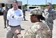 U.S. Army Maj. Tauara Hodo, center, 841st Transportation Battalion executive officer, briefs Rick Trimble, left, military legislative assistant to Senator Tim Scott, on the role of the 841st Trans Btn. while Col. Jeff Nelson, 628th Air Base Wing commander, looks on during a tour of Joint Base Charleston May 2, 2018.