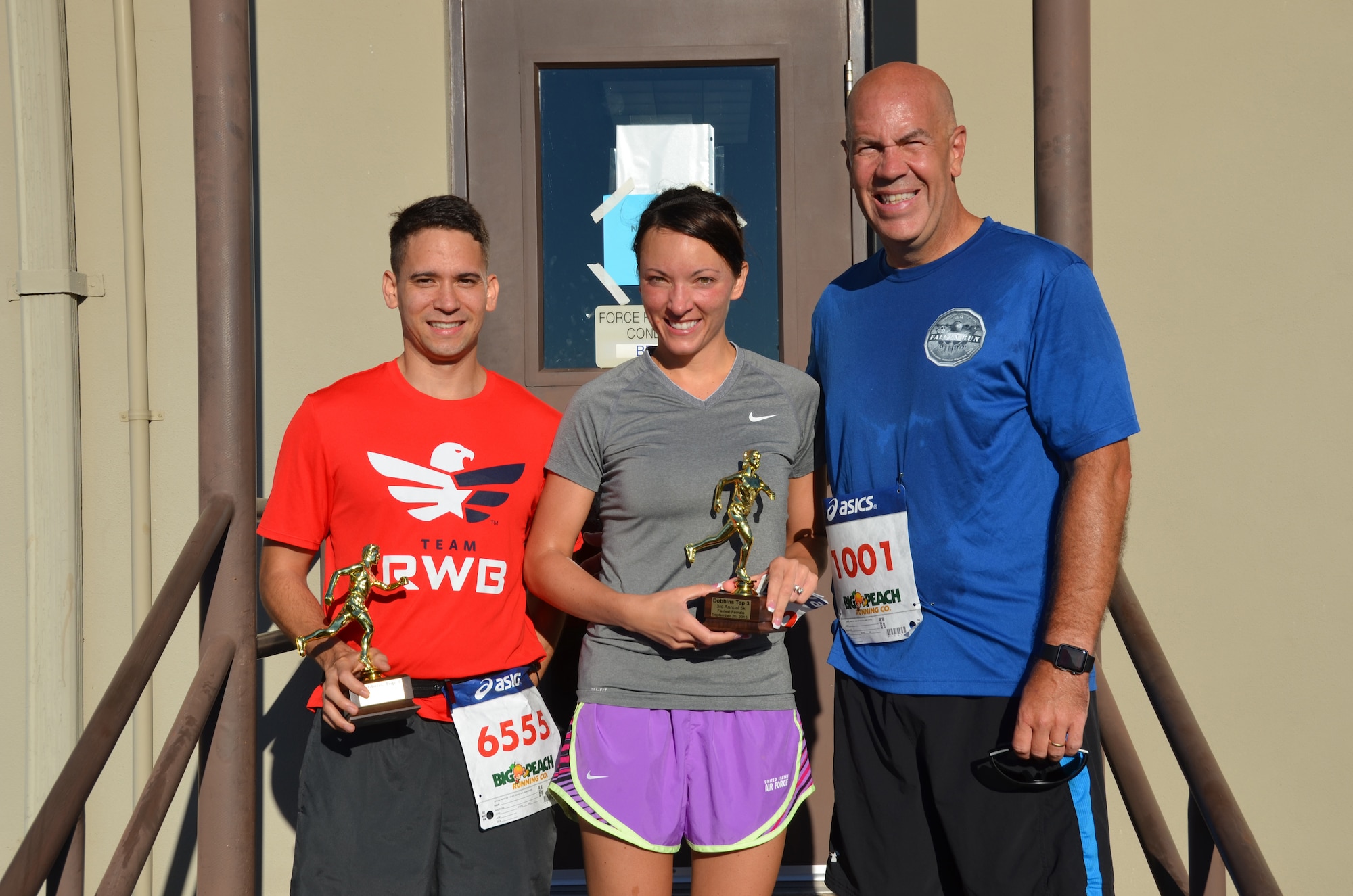 Col. Brent Merritt, 94th Airlift Wing commander; Senior Airman David Flynn, 94th Aeromedical Staging Squadron; and Capt. Rebecca Nistler, 94th Operations Group, pose for a photo after the Falcon 5k Sept. 13, 2015, at Dobbins Air Reserve Base, Ga. Flynn and Nistler were the first male and
female finishers of the fun run sponsored by the Dobbins Top 3. (U.S. Air Force photo/Staff Sgt. Kelly Goonan)
