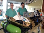 Sgt. AliceAnn Meyer (left), U.S. Army Institute of Surgical Research Burn Flight Team NCO in charge and respiratory therapist, and Capt. Cassandra Bullock (right), U.S. Army Institute of Surgical Research Burn Flight Team chief flight nurse, inspect equipment used for the treatment and care of critical burn patients being transported on military aircraft from locations around the world en route to San Antonio, home of the USAIR Burn Center located at Joint Base San Antonio-Fort Sam Houston.