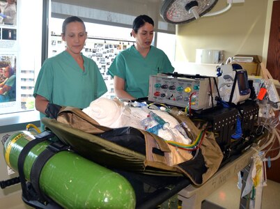 Sgt. AliceAnn Meyer (left), U.S. Army Institute of Surgical Research Burn Flight Team NCO in charge and respiratory therapist, and Capt. Cassandra Bullock (right), U.S. Army Institute of Surgical Research Burn Flight Team chief flight nurse, inspect equipment used for the treatment and care of critical burn patients being transported on military aircraft from locations around the world en route to San Antonio, home of the USAIR Burn Center located at Joint Base San Antonio-Fort Sam Houston.