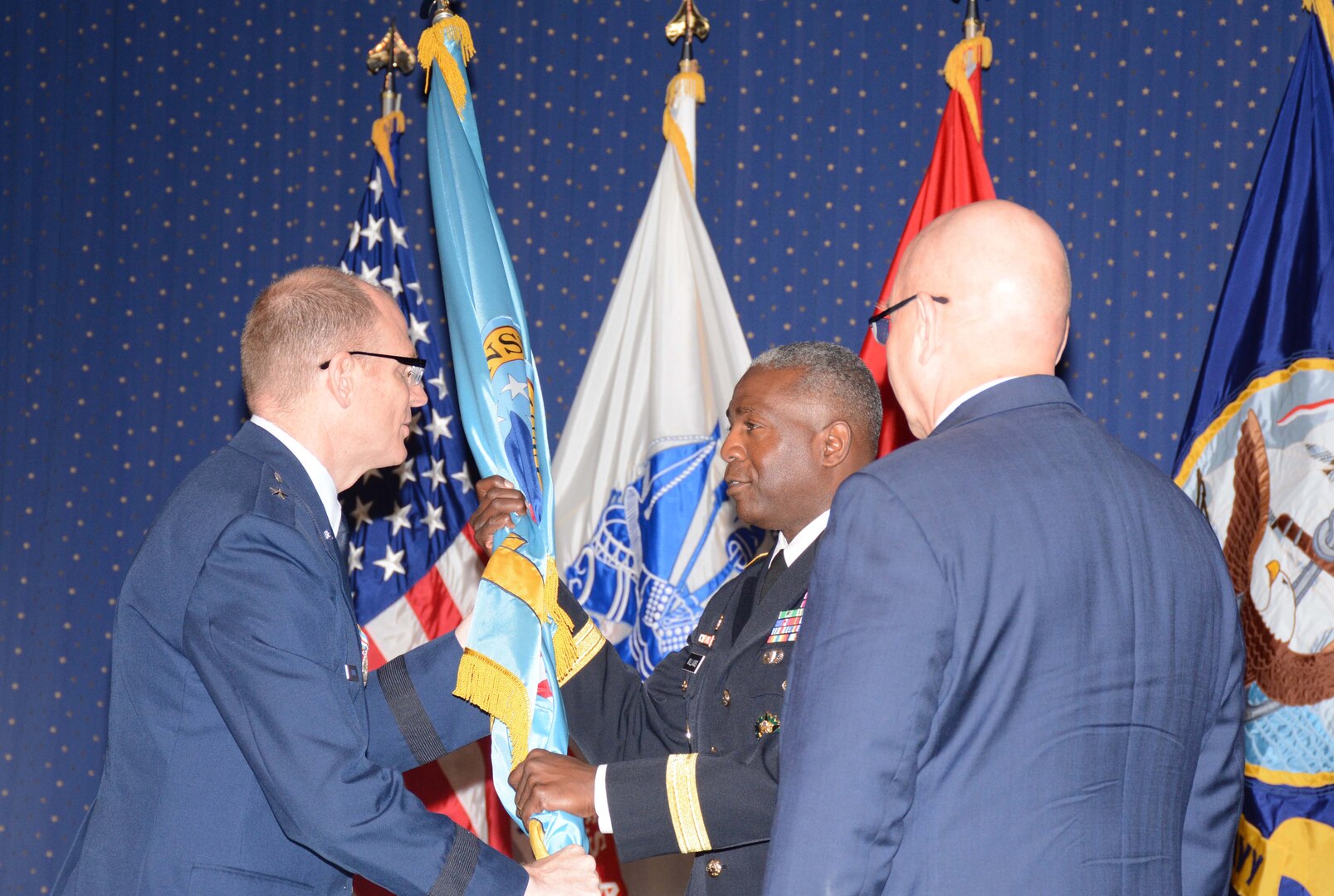 A symbolic transfer of power occurs with a passing of the organization's colors.