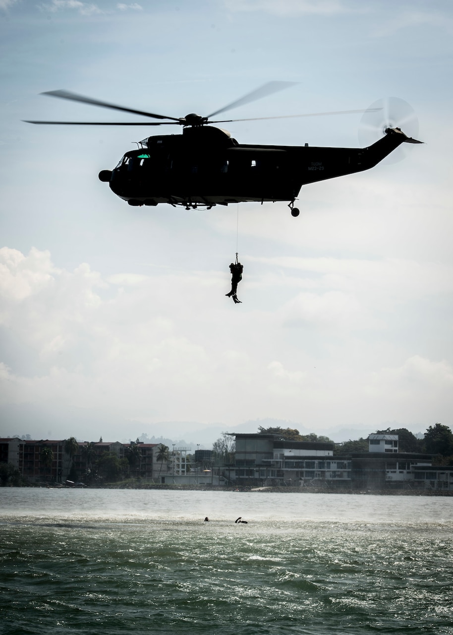 A Malaysian air force helicopter rescues mock casualties as part of a maritime search-and-rescue exercise during Pacific Partnership 2018 in Tawau, Malaysia.