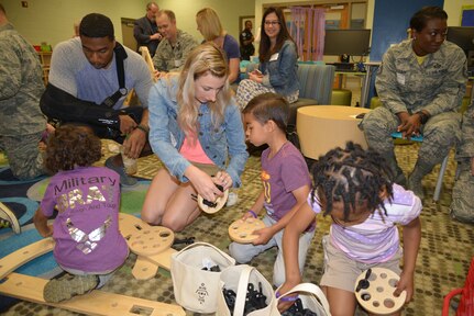 Parents and students play together during a "reveal" celebration as part of the Month of the Military Child at Lambs Elementary School, Charleston, S.C., April 13, 2018.