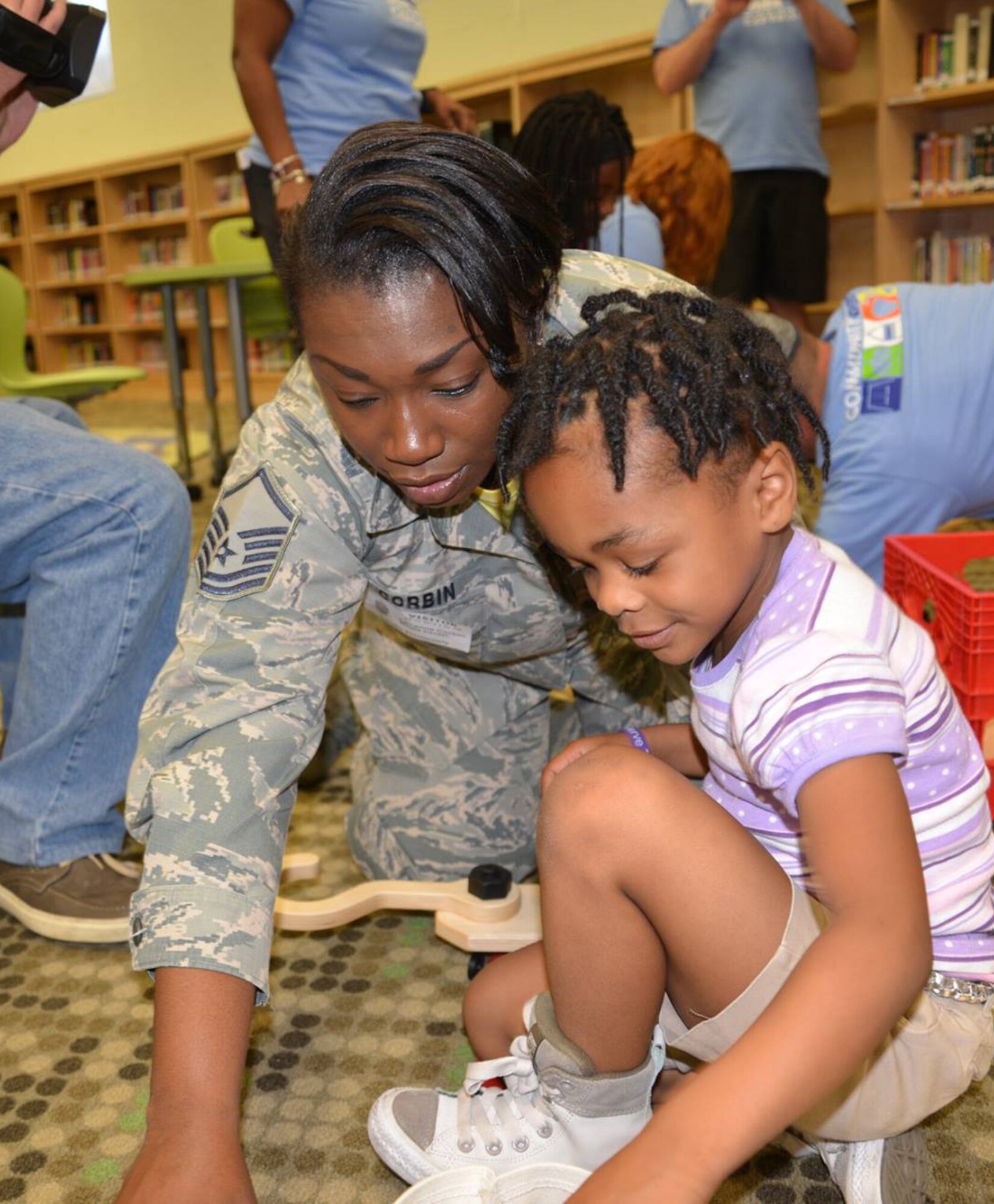 Master Sgt. Lavanna Corbin, 628th Force Support Squadron force management section chief, plays with her daughter Brianna Corbin during a "reveal" celebration as part of the Month of the Military Child at Lambs Elementary School, Charleston, South Carolina, April 13, 2018.