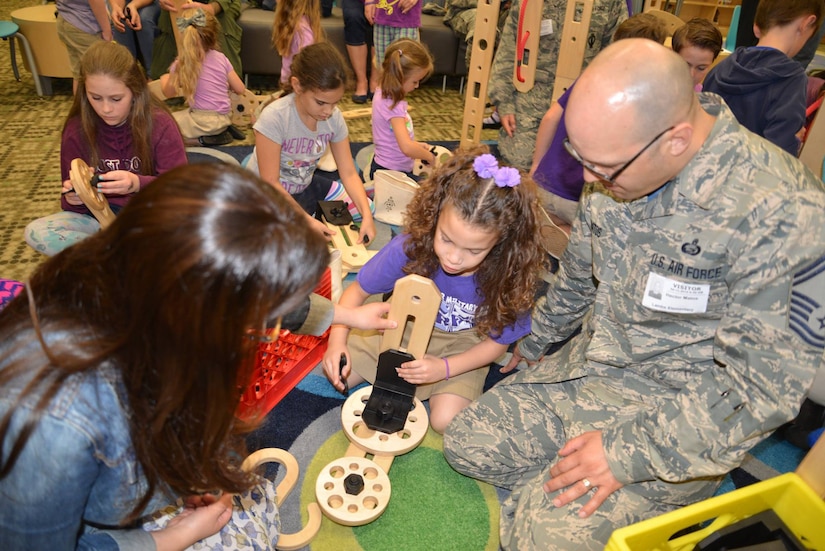 Parents and students play together during a "reveal" celebration as part of the Month of the Military Child at Lambs Elementary School, Charleston, S.C., April 13, 2018.