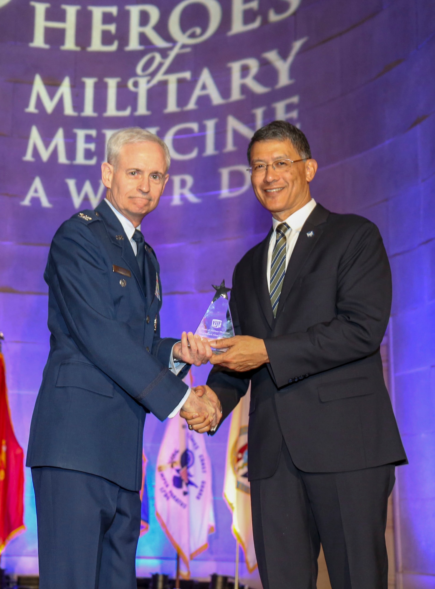 U.S. Air Force Maj. Gen. (retired) Joseph Caravalho (right), president, Henry M. Jackson Foundation for the Advancement of Military Medicine, congratulates U.S. Air Force Col. William E. Nelson, chief, integrated and international operational medicine, 711th Human Performance Wing, after receiving the 2018 Heroes of Military Medicine Award in Washington, D.C., May 3, 2018. Col. Nelson was recognized for his exemplary career as an Air Force flight surgeon, and for his contributions to the Air Force Integrated Operational Support mission. (Courtesy photo illustration by Henry M. Jackson Foundation for the Advancement of Military Medicine)