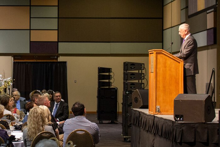 Defense Secretary James N. Mattis speaks to an audience from a podium.