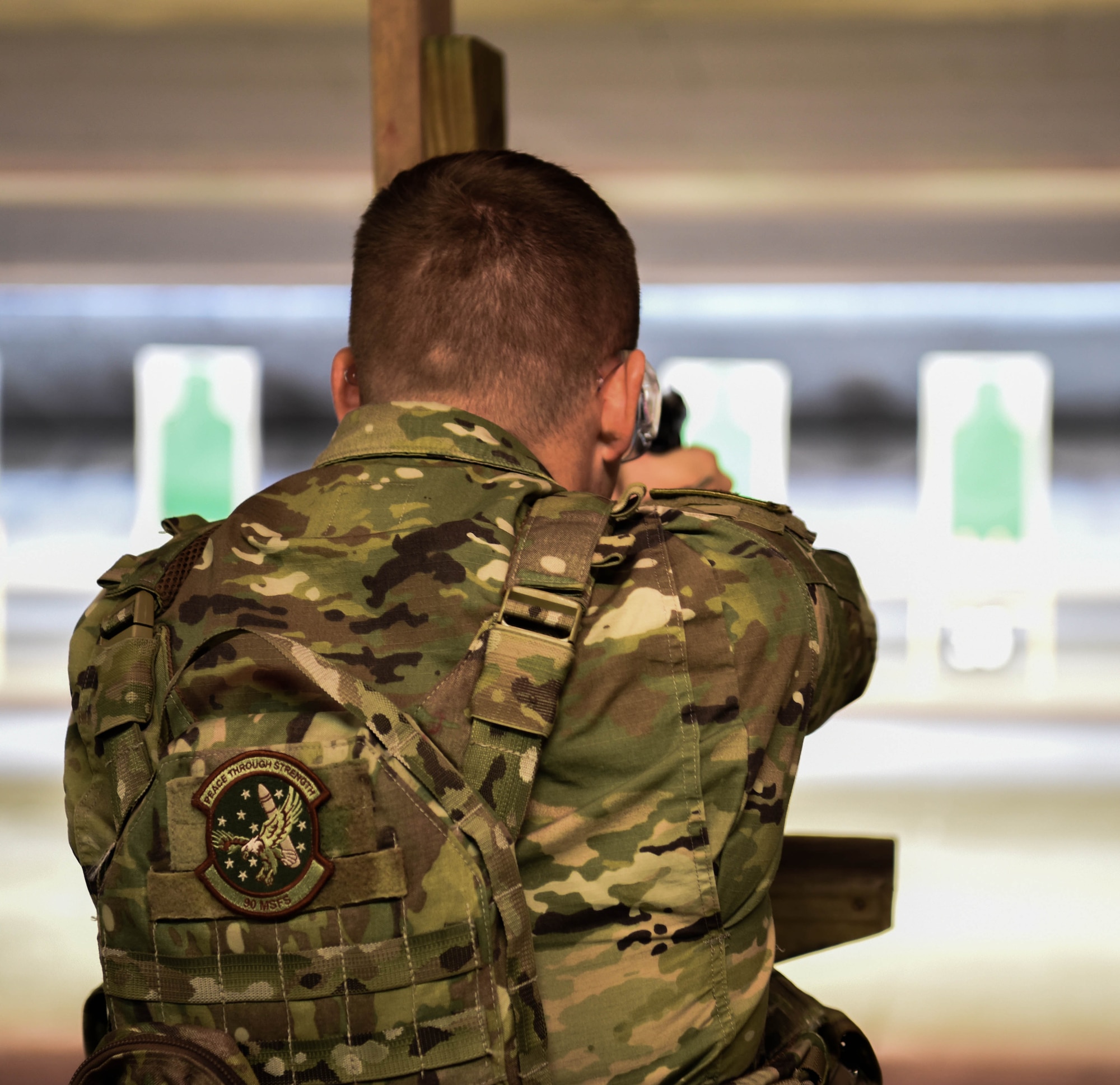 2nd Lt. Mark Stacy, 90th Missile Security Forces Squadron flight commander, aims down the sights of an M-9 Berretta March 23, 2018, at the Combat Arms Training and Maintenance range on F.E. Warren Air Force Base Wyo. On top of teaching and qualifying non security Airmen, CATM also helps missile security forces and base security forces personnel requalify on the weapons they use in their everyday job. Combat Arms Training and Maintenance is a vital component to keeping our Airmen trained and qualified on the weapon systems they are issued when performing security on home station or deployed. (U.S. Air Force photo by Airman 1st Class Braydon Williams)