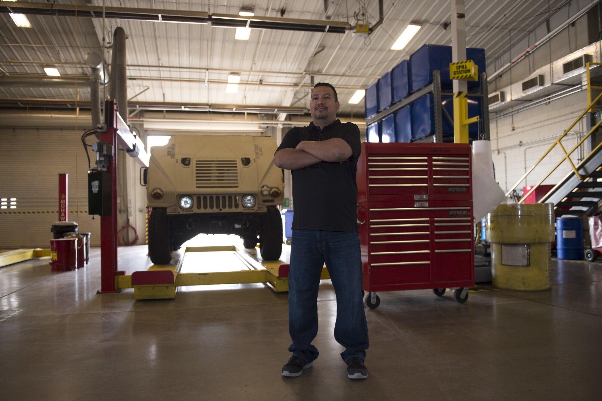 Julio Cedillo, a Vehicle Maintenance and control assistant assigned to the 97th Logistics Readiness Squadron, stands in the vehicle maintenance shop, April 17, 2018, at Altus Air Force Base, Okla.