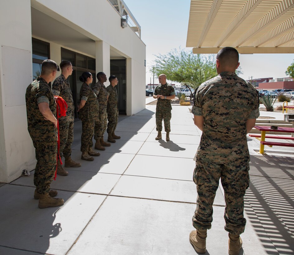 Newly promoted U.S. Marine Corps corporals assigned to Marine Corps Air Station (MCAS) Yuma Headquarters & Headquarters Squadron (H&HS) received their blood stripes during a Blood Stripe Ceremony in front of the H&HS building May 3, 2018. The blood stripe honors the blood that was shed by Marine officers and noncommissioned officers (NCO) during the Battle of Chapultepec in 1847. The blood stripes are sewn on the trousers of NCOs, Staff NCOs, and officers in remembrance of those who courageously fought in the battle. (U.S. Marine Corps photo by Lance Cpl. Sabrina Candiaflores)