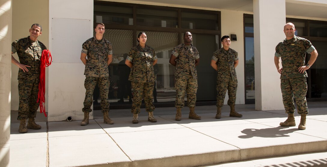 Newly promoted U.S. Marine Corps corporals assigned to Marine Corps Air Station (MCAS) Yuma Headquarters & Headquarters Squadron (H&HS) received their blood stripes during a Blood Stripe Ceremony in front of the H&HS building May 3, 2018. The blood stripe honors the blood that was shed by Marine officers and noncommissioned officers (NCO) during the Battle of Chapultepec in 1847. The blood stripes are sewn on the trousers of NCOs, Staff NCOs, and officers in remembrance of those who courageously fought in the battle. (U.S. Marine Corps photo by Lance Cpl. Sabrina Candiaflores)