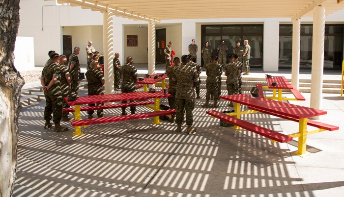 Newly promoted U.S. Marine Corps corporals assigned to Marine Corps Air Station (MCAS) Yuma Headquarters & Headquarters Squadron (H&HS) received their blood stripes during a Blood Stripe Ceremony in front of the H&HS building May 3, 2018. The blood stripe honors the blood that was shed by Marine officers and noncommissioned officers (NCO) during the Battle of Chapultepec in 1847. The blood stripes are sewn on the trousers of NCOs, Staff NCOs, and officers in remembrance of those who courageously fought in the battle. (U.S. Marine Corps photo by Lance Cpl. Sabrina Candiaflores)