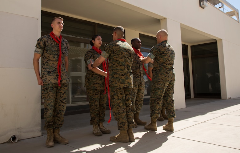 Newly promoted U.S. Marine Corps corporals assigned to Marine Corps Air Station (MCAS) Yuma Headquarters & Headquarters Squadron (H&HS) received their blood stripes during a Blood Stripe Ceremony in front of the H&HS building May 3, 2018. The blood stripe honors the blood that was shed by Marine officers and noncommissioned officers (NCO) during the Battle of Chapultepec in 1847. The blood stripes are sewn on the trousers of NCOs, Staff NCOs, and officers in remembrance of those who courageously fought in the battle. (U.S. Marine Corps photo by Lance Cpl. Sabrina Candiaflores)