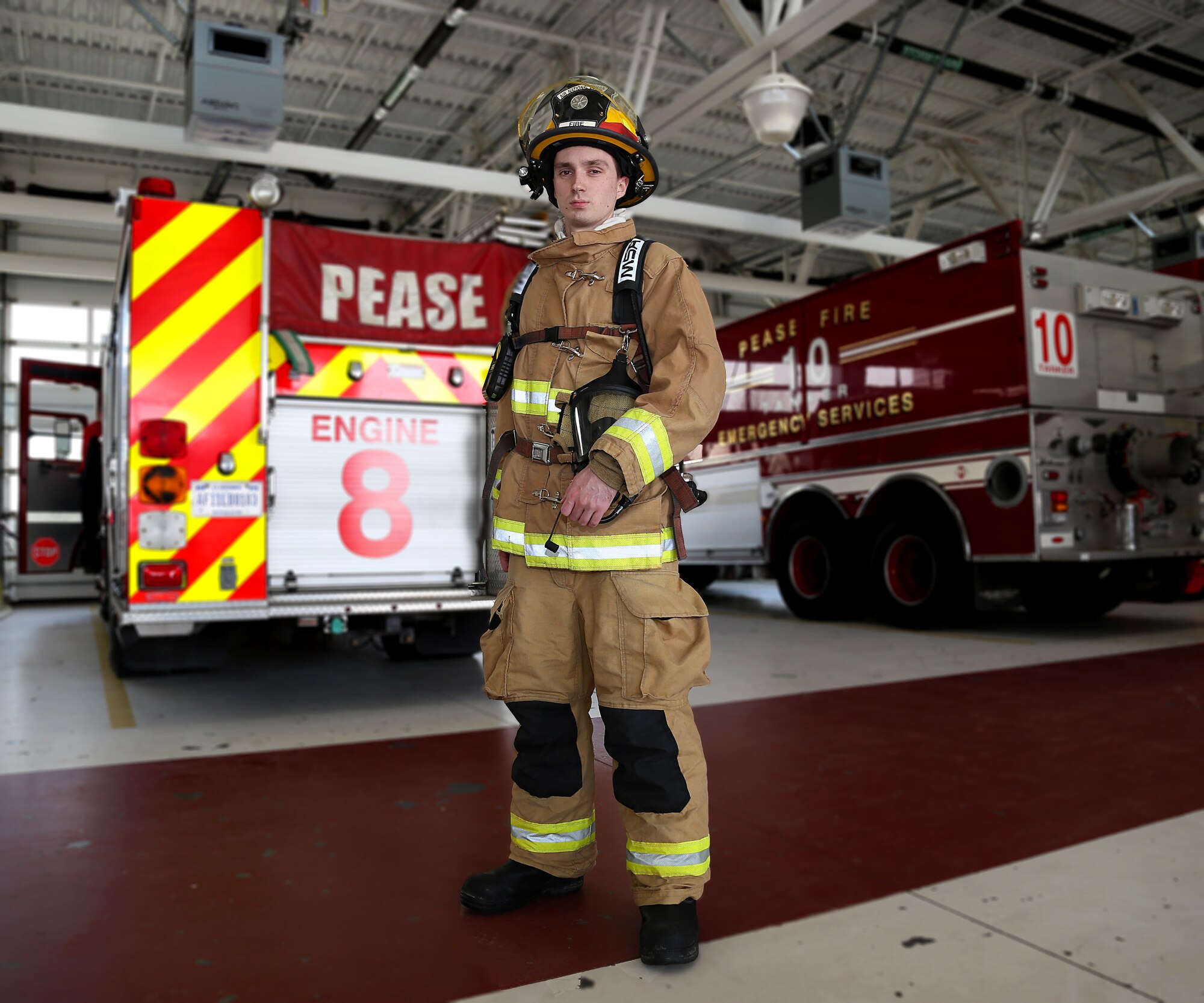 Senior Airman Alex J. Lane, an aircraft rescue firefighter assigned to the 157th Air Refueling Wing Fire Department, poses for a portrait behind a fire engine on May 4, 2018 at Pease Air National Guard Base, N.H. Lane completed his technical training in 2014. (N.H. Air National Guard photo by Staff Sgt. Kayla White)