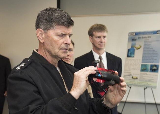 Vice Chief of Naval Operations Adm. Bill Moran, USN, looks at virtual reality goggles used by Naval Surface Warfare Center Panama City Division scientists and engineers for mine warfare prototypes. The VCNO visited the command, located in Panama City, Florida May 3, 2018, to learn more about their mission area support to the U.S. Navy. (RELEASED) U.S. Navy photo by Ron Newsome, NSWC PCD.