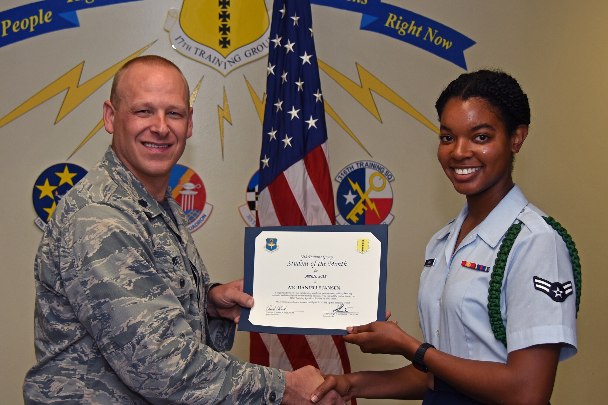 U.S. Air Force Lt. Col. Steven Watts, 17th Training Group deputy commander, presents the 315th Training Squadron Student of the Month award to Airman 1st Class Danielle Jansen, 315th TRS trainee, at Brandenburg Hall on Goodfellow Air Force Base, Texas, May 4, 2018. The 315th TRS’s vision is to develop combat-ready intelligence, surveillance and reconnaissance professionals and promote an innovative squadron culture and identity unmatched across the U.S. Air Force. (U.S. Air Force photo by Airman 1st Class Zachary Chapman/Released)