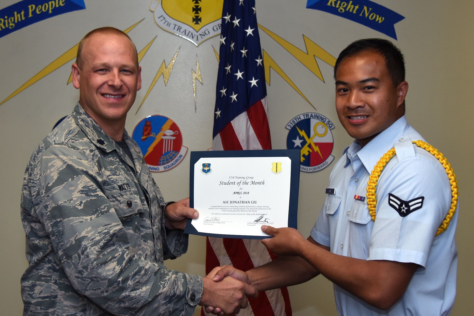 U.S. Air Force Lt. Col. Steven Watts, 17th Training Group deputy commander, presents the 312th Training Squadron Student of the Month award to Airman 1st Class Jonathan Liu, 312th TRS trainee, at Brandenburg Hall on Goodfellow Air Force Base, Texas, May 4, 2018. The 312th TRS’s mission is to provide Department of Defense and international customers with mission ready fire protection and special instruments graduates and provide mission support for the Air Force Technical Applications Center. (U.S. Air Force photo by Airman 1st Class Zachary Chapman/Released)