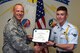 U.S. Air Force Lt. Col. Steven Watts, 17th Training Group deputy commander, presents the 316th Training Squadron Student of the Month award to Airman Jonah Chose, 316th TRS trainee, at Brandenburg Hall on Goodfellow Air Force Base, Texas, May 4, 2018. The 316th TRS’s mission is to conduct U.S. Air Force, U.S. Army, U.S. Marine Corps, U.S. Navy and U.S. Coast Guard cryptologic, human intelligence and military training. (U.S. Air Force photo by Airman 1st Class Zachary Chapman/Released)
