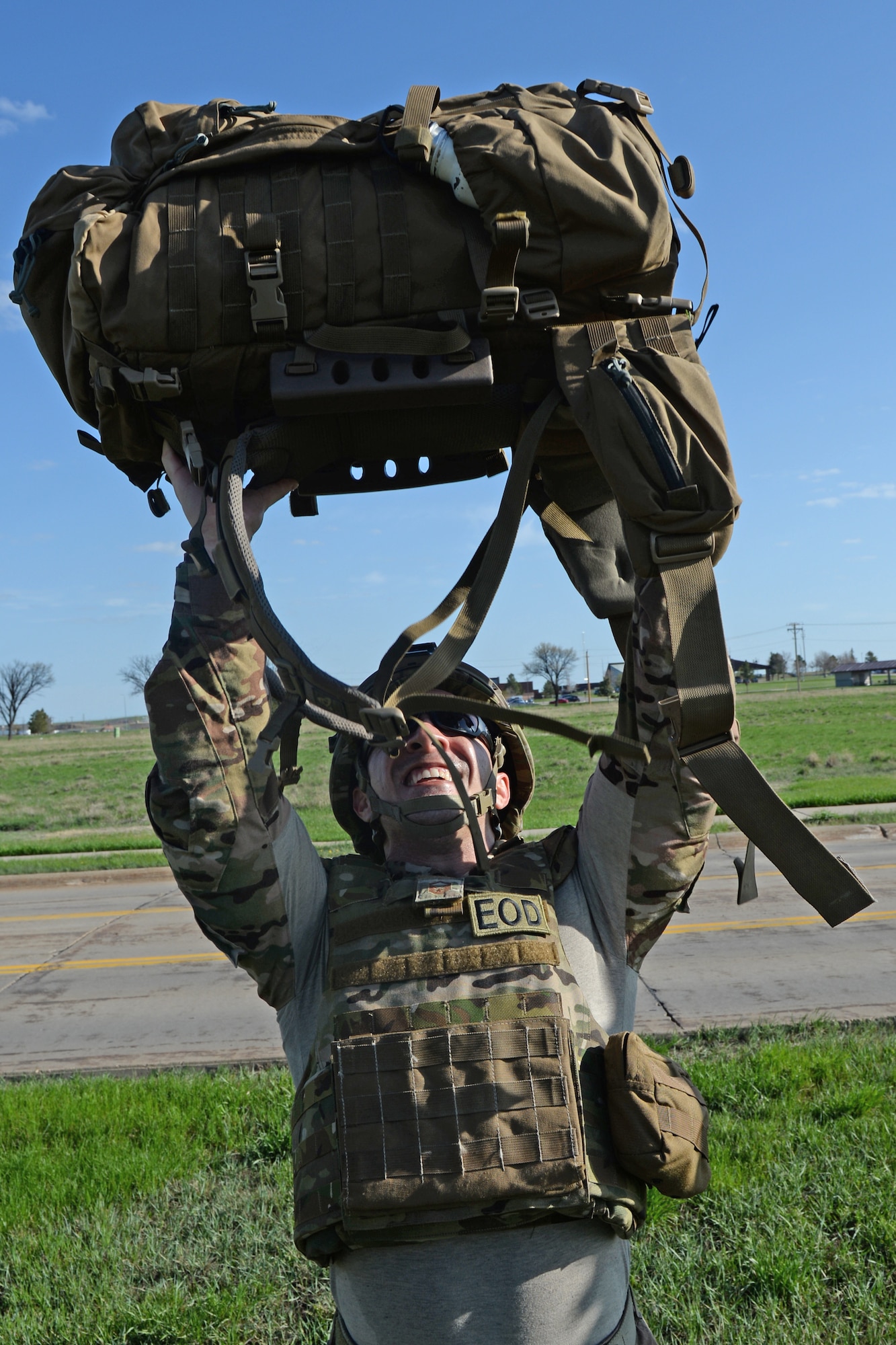 Master Sgt. Carlos Sanchez, 28th Civil Engineer Explosive Ordnance Disposal flight lead, performs 32 ruck presses during the 50th Anniversary EOD Memorial Day ruck march at Ellsworth Air Force Base, S.D., May 4, 2018. The 32 repetitions of the exercises represent the 32 fallen EOD Airmen who have been killed in the line of duty since 9/11.  (U.S. Air Force photo by Airman 1st Class Nicolas Z. Erwin)