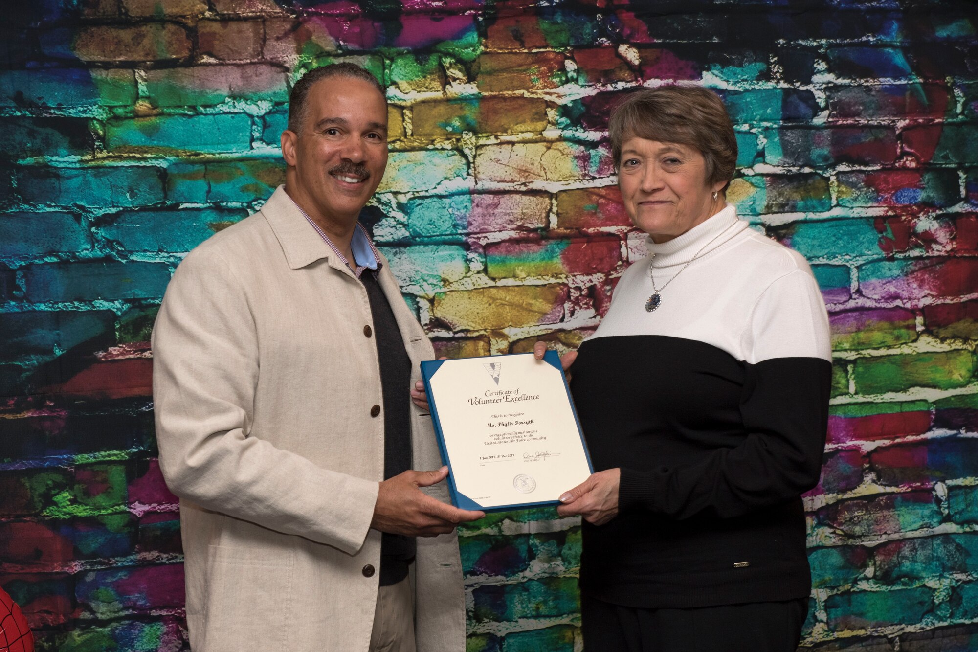 Col. David Cochran, 167th Airlift Wing vice commander, presented Phylis Forsythe, a volunteer for the 167th Family Readiness Group, with an award for her outstanding volunteer service, at an appreciation dinner, April 16. (U.S. Air National Guard photo by Senior Master Sgt. Emily Beightol-Deyerle)